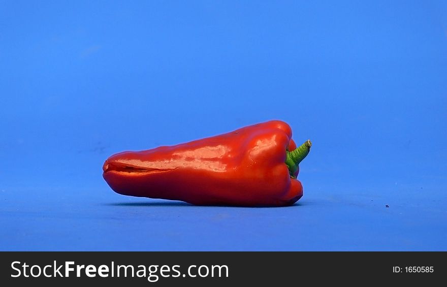 Picture of a hot red pepper ina blue background