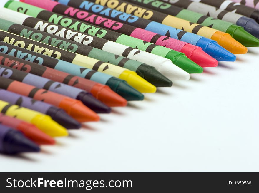Multi Coloured Crayons set against a plain backgrund.