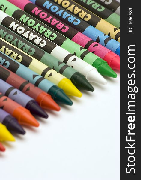 Multi Coloured Crayons set against a plain backgrund.