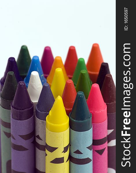 Multi Coloured Crayons set against a plain backgrund.