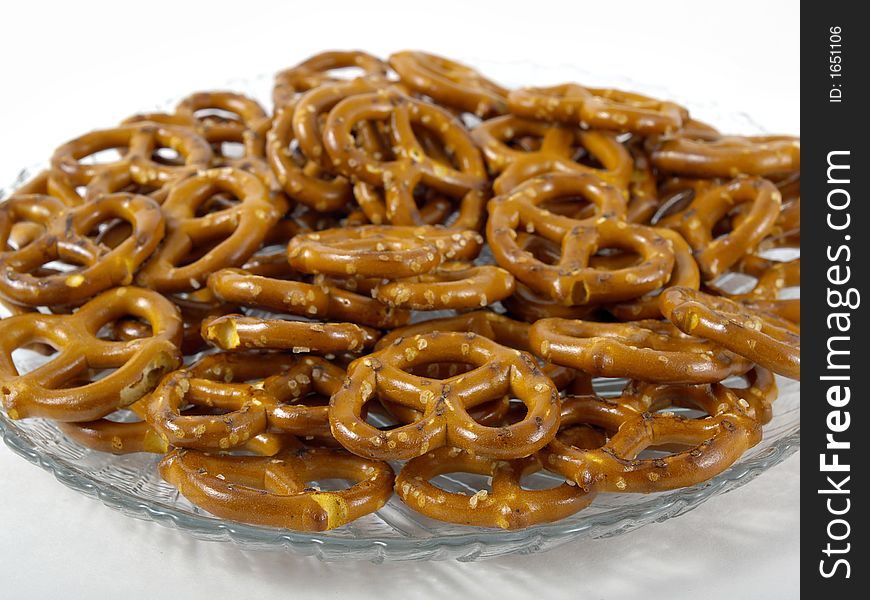 Pretzels on a clear glass plate with whit background