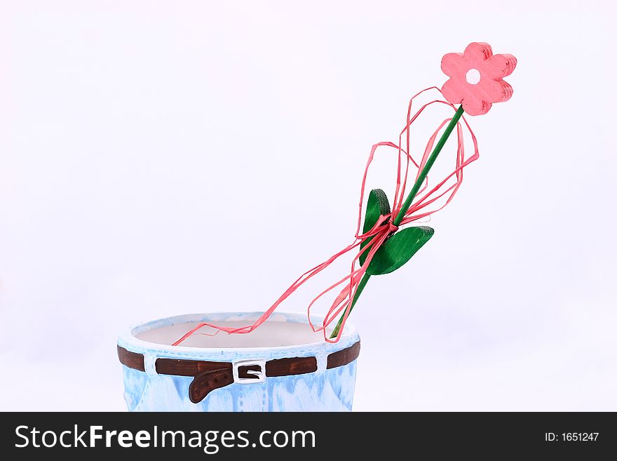 Wooden flower in flowerpot isolated on background