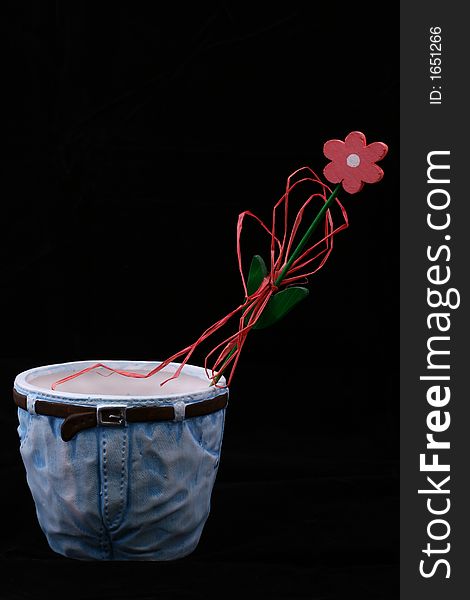 Wooden flower in flowerpot isolated on black background