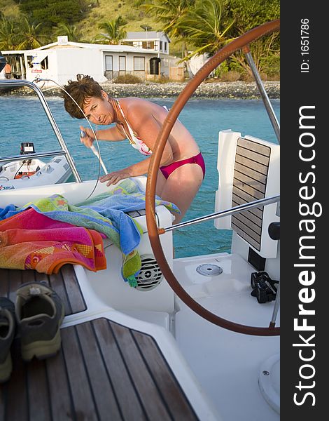 Shot of a lovely woman on a sailboat in a bikini. Shot of a lovely woman on a sailboat in a bikini.