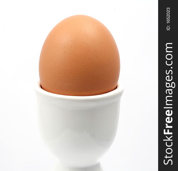 Egg ceramic holder and eggs on a white background. Egg ceramic holder and eggs on a white background