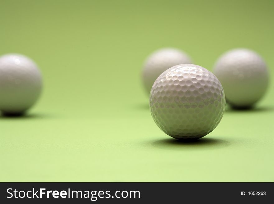 A few golfballs with green background