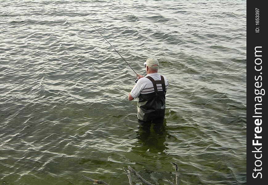 Man fishing in waist high water