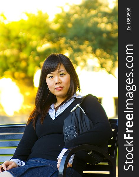 Young asian girl sit on bench