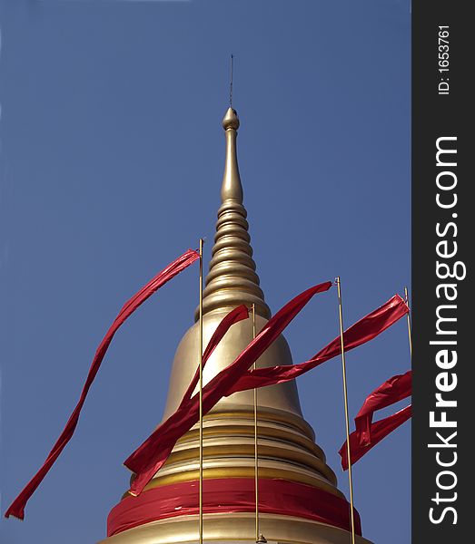 Golden Cheddi with red flags at Buddhist temple in Thailand. Golden Cheddi with red flags at Buddhist temple in Thailand.