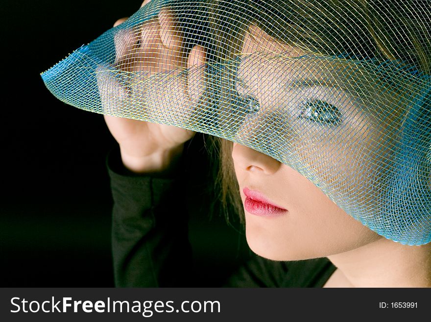 Face of woman with stylish grid as a hat. Face of woman with stylish grid as a hat