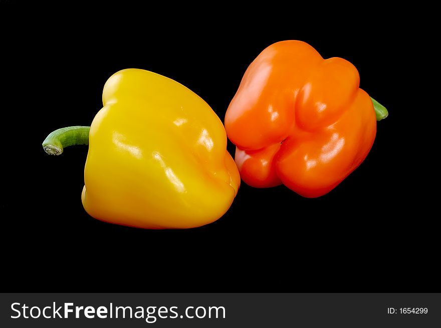 Two sweet peppers on black. Two sweet peppers on black