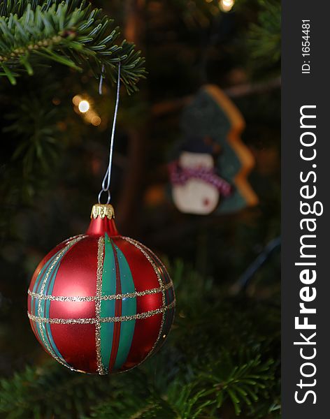 Red, green and gold christmas ornament hanging on a tree. Red, green and gold christmas ornament hanging on a tree