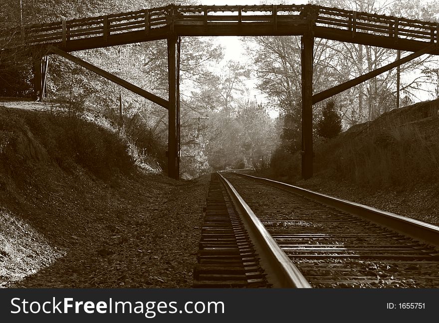 Railroad tracks under the footbridge in old NC town. Railroad tracks under the footbridge in old NC town.