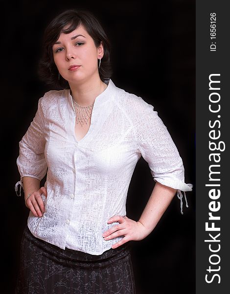 Portrait of Beautiful brunette woman on black background wearing white shirt