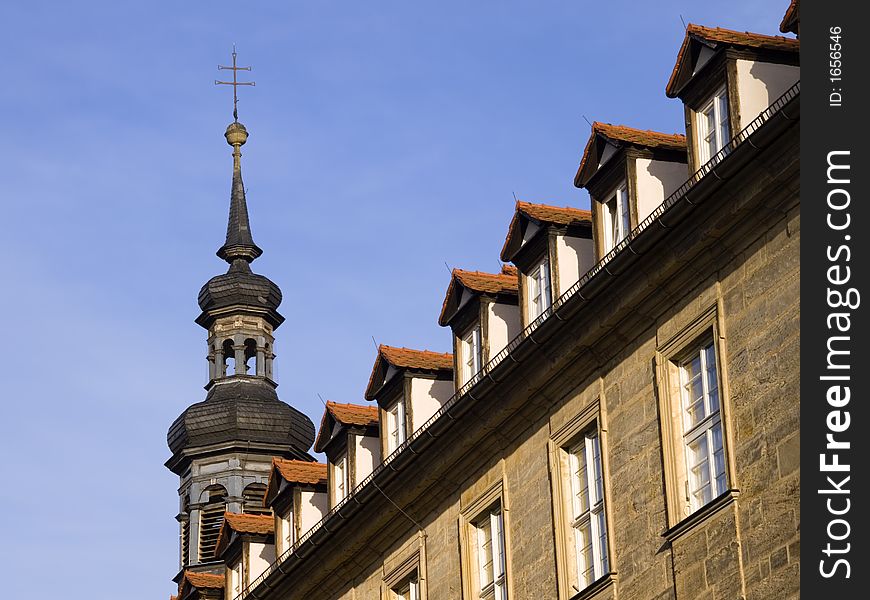 Facade of an old school building with church tower. Facade of an old school building with church tower