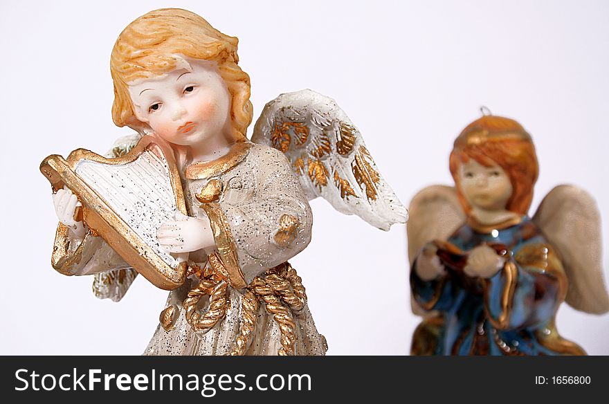 Two ceramic christmas angel on a white backgorund. Two ceramic christmas angel on a white backgorund