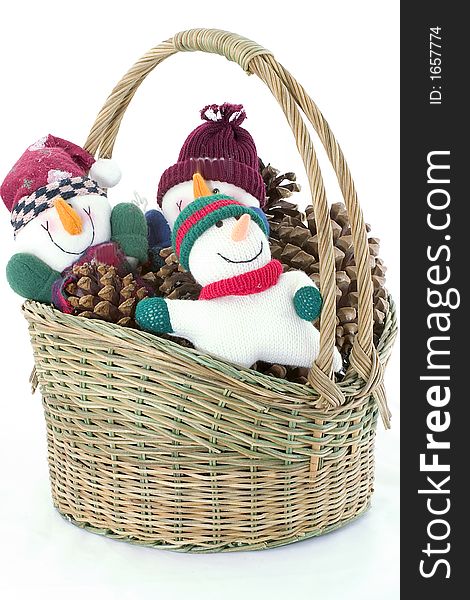 A festive basket filled with funny snowmen and pine-cones. A festive basket filled with funny snowmen and pine-cones