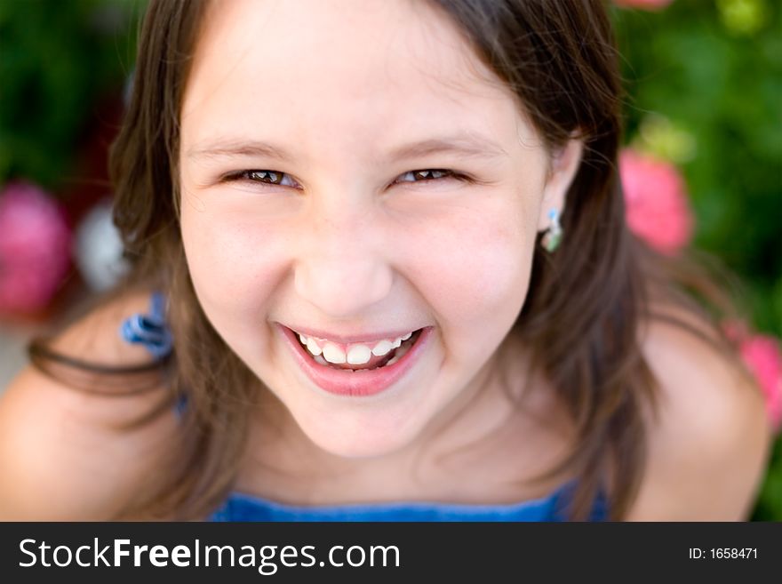 Girl with brown long hair and earrings laughing and just being happy. Girl with brown long hair and earrings laughing and just being happy