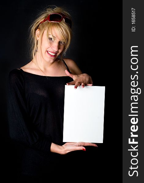 Girl presenting an empty piece of paper, ready to place your message or your ad on. Girl presenting an empty piece of paper, ready to place your message or your ad on