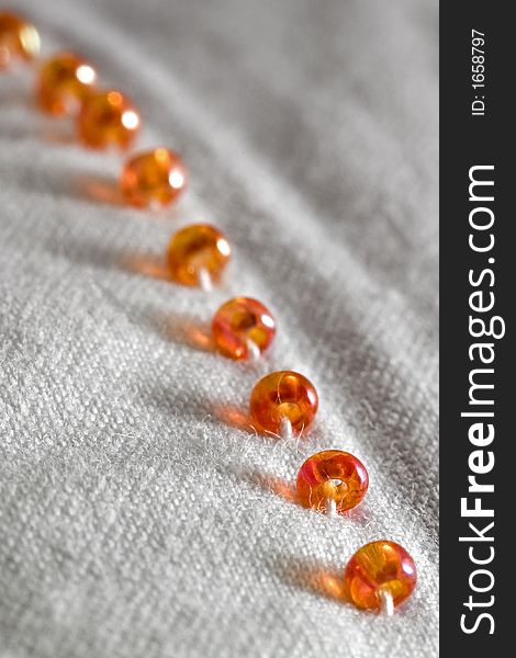 Plastic beads on white cotton