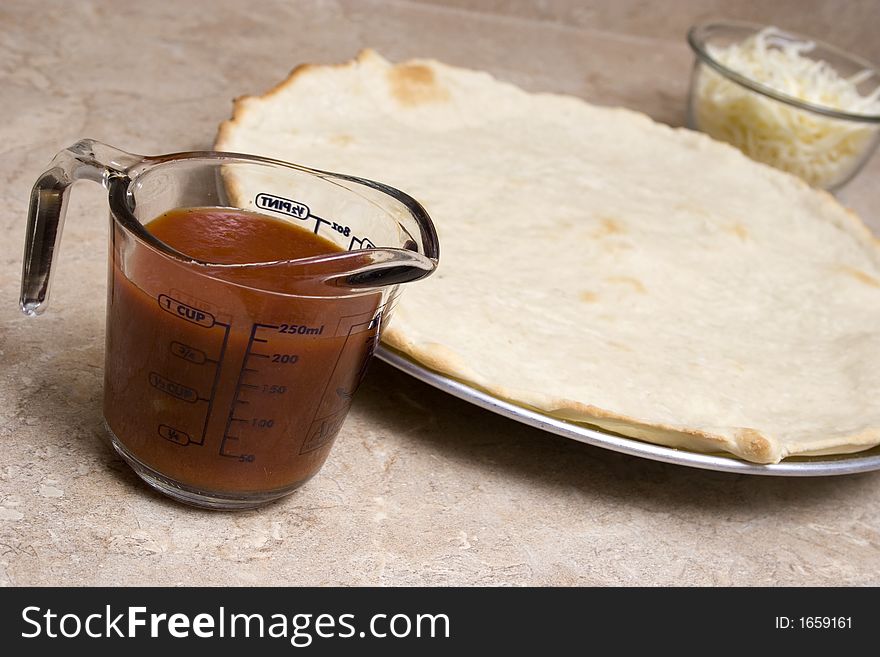 Pizza ingredients sit on table top. Pizza ingredients sit on table top