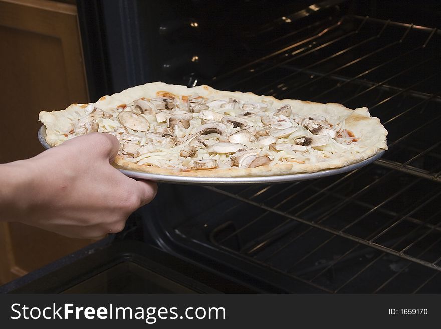Pizza is placed into the oven