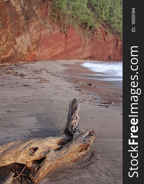 Sand, water and red cliffs of Koki Beach, Maui