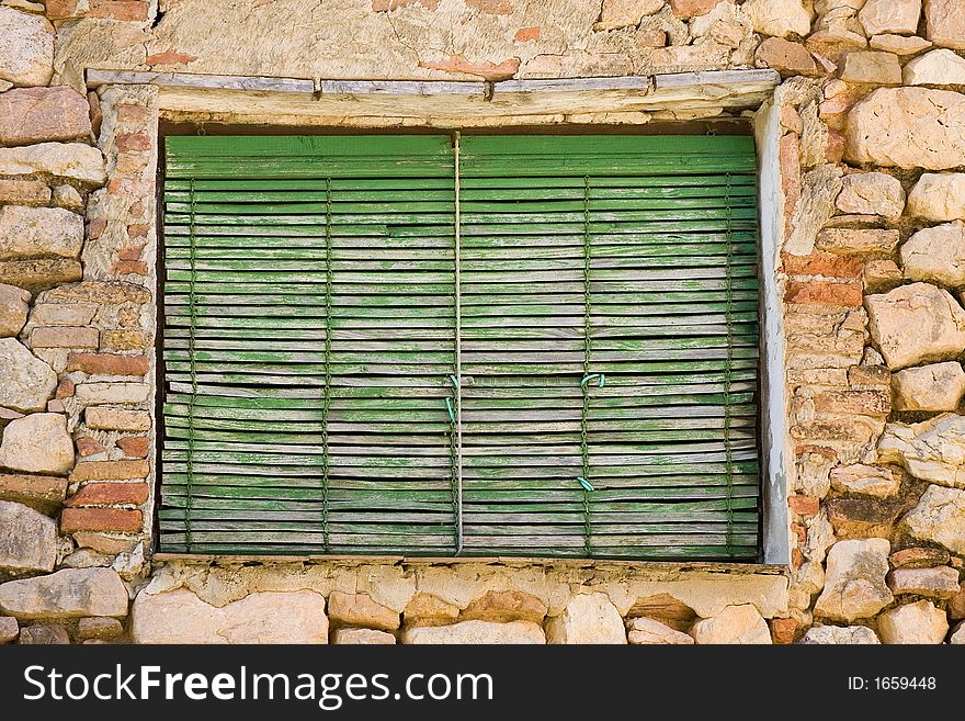 Weathered window with an aged green shade. Weathered window with an aged green shade