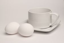 White Cup And Two Eggs Royalty Free Stock Photo