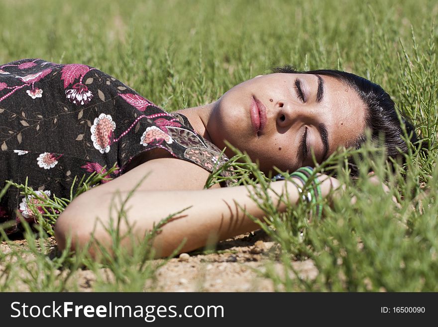 Beautiful girl with floral dress sleeping on the nature. Beautiful girl with floral dress sleeping on the nature.
