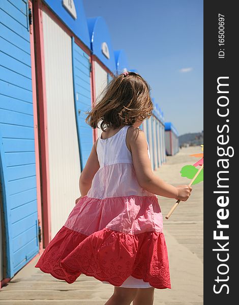 young girl with a color dress, walking near chalet. young girl with a color dress, walking near chalet