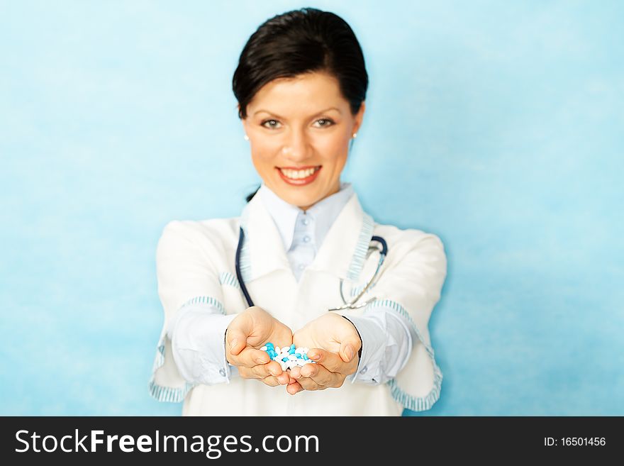 Caucasian woman as a doctor holding meds