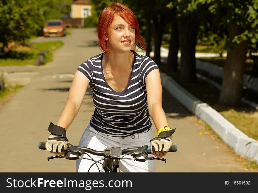 Young Adult Smiling Biker Woman On Mounting Bike