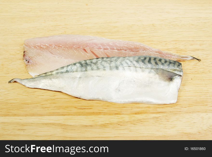 Fresh mackerel fish fillets on a wooden board