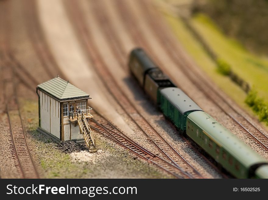 Signal box and locomotive on a miniature train set with shallow d.o.f