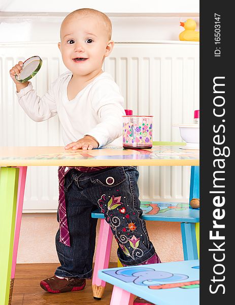 Little girl at the table in the kitchen. Little girl at the table in the kitchen.