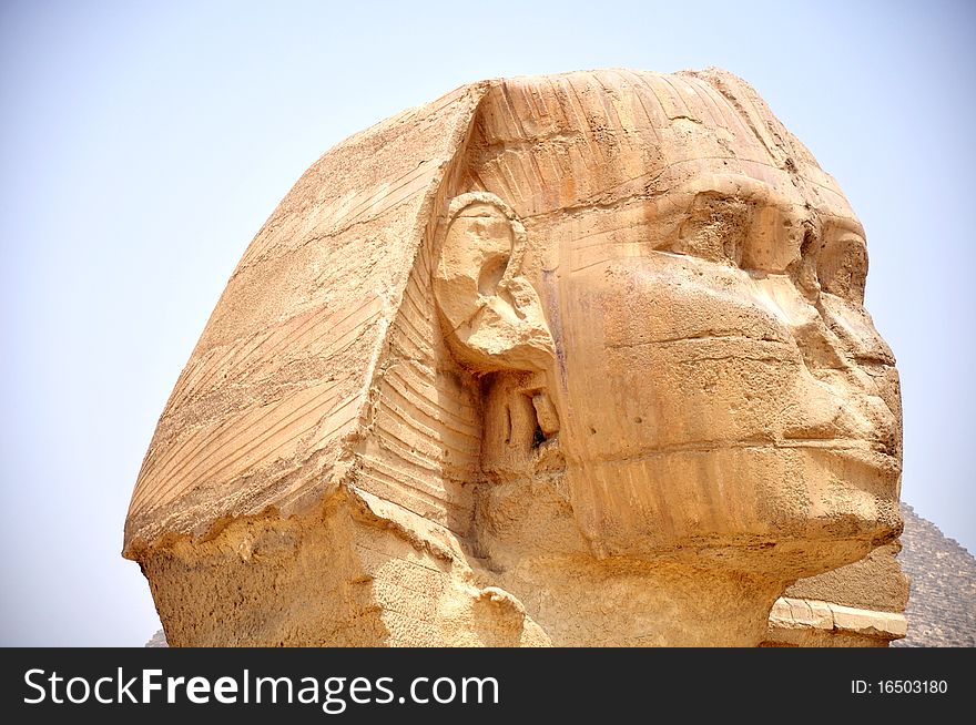 Close-up view of the famous Sphynx in front the giant pyramid,Egypt.