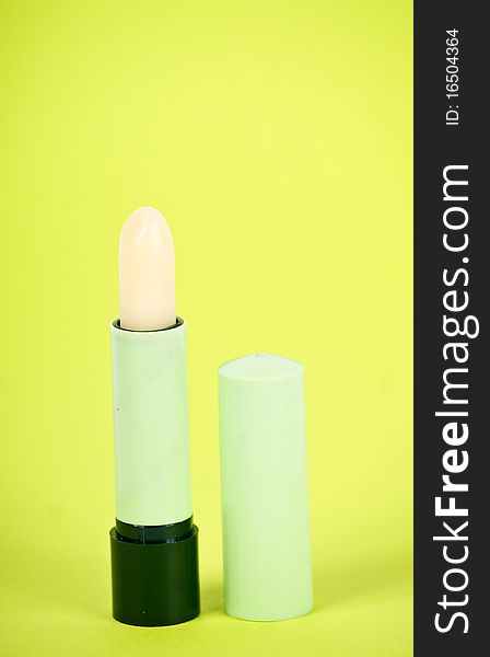 Lipstick isolated on green background