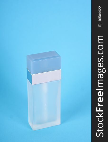 Parfume bottle isolated on a blue background