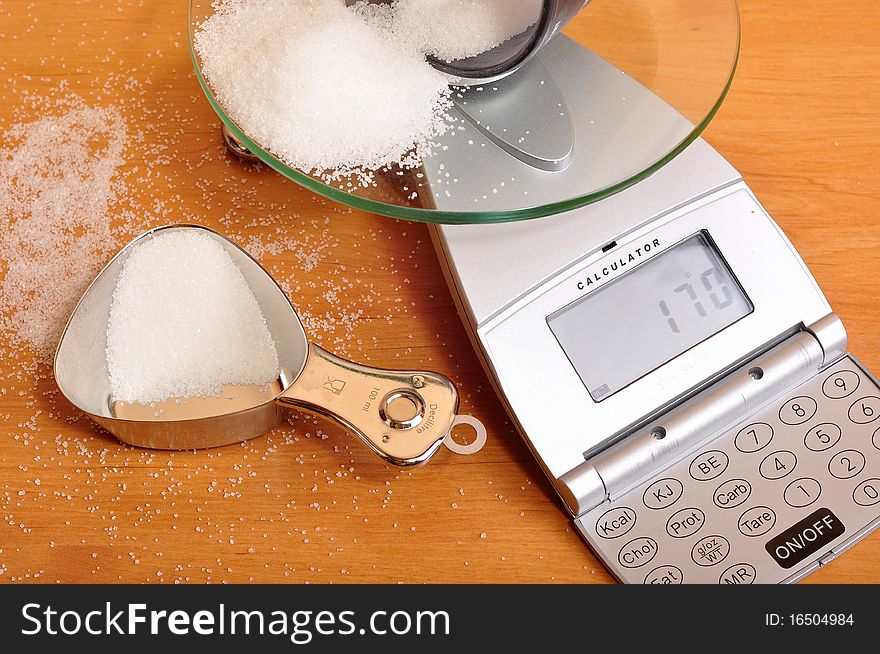 Photo of weighing sugar on scale.