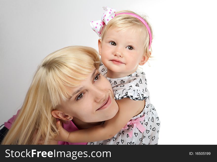 Beautiful child girl playing with toys and her mother. Beautiful child girl playing with toys and her mother