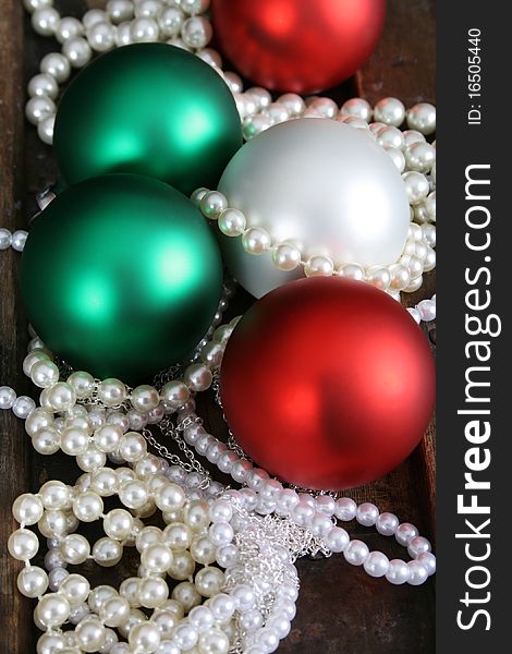 Christmas decoration balls and pearl jewellery necklaces. Christmas decoration balls and pearl jewellery necklaces