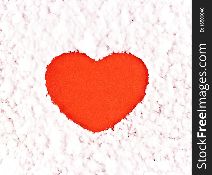 A red heart on the artificial snow background