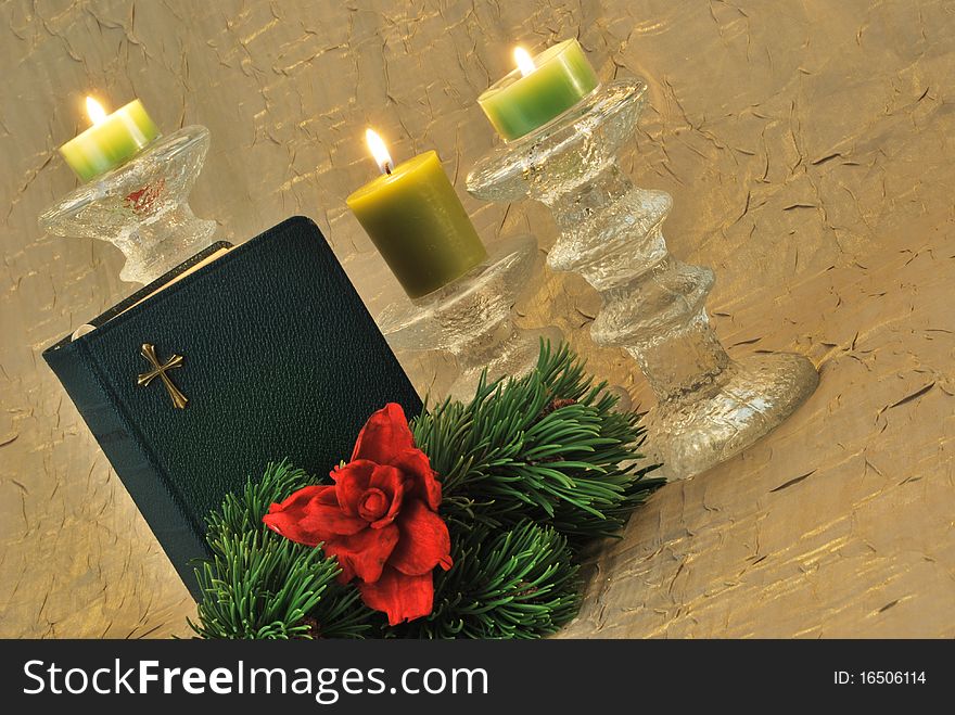 Green bible with pine branch and candles. Green bible with pine branch and candles