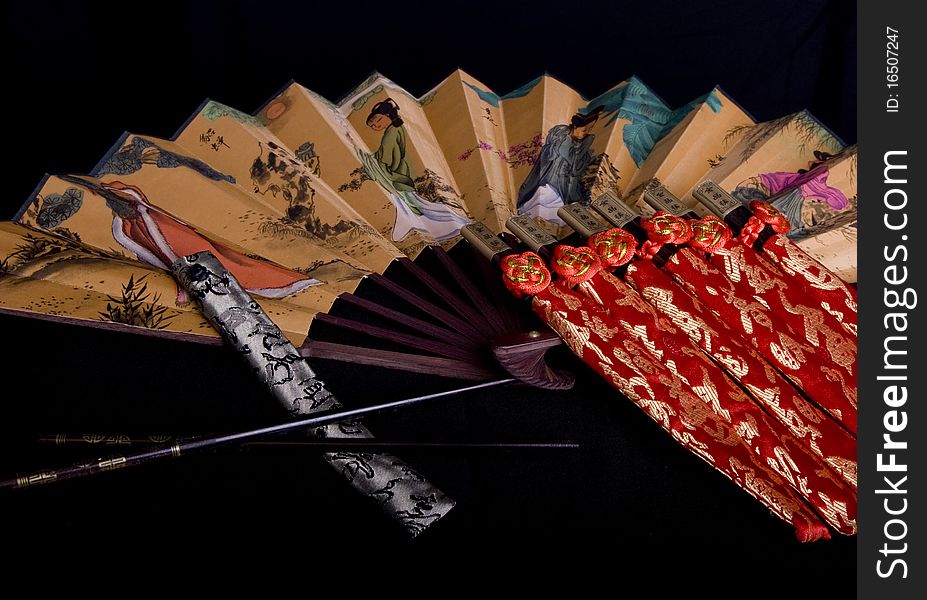 Arranged chinese chopsticks accompanied by a fan. Arranged chinese chopsticks accompanied by a fan