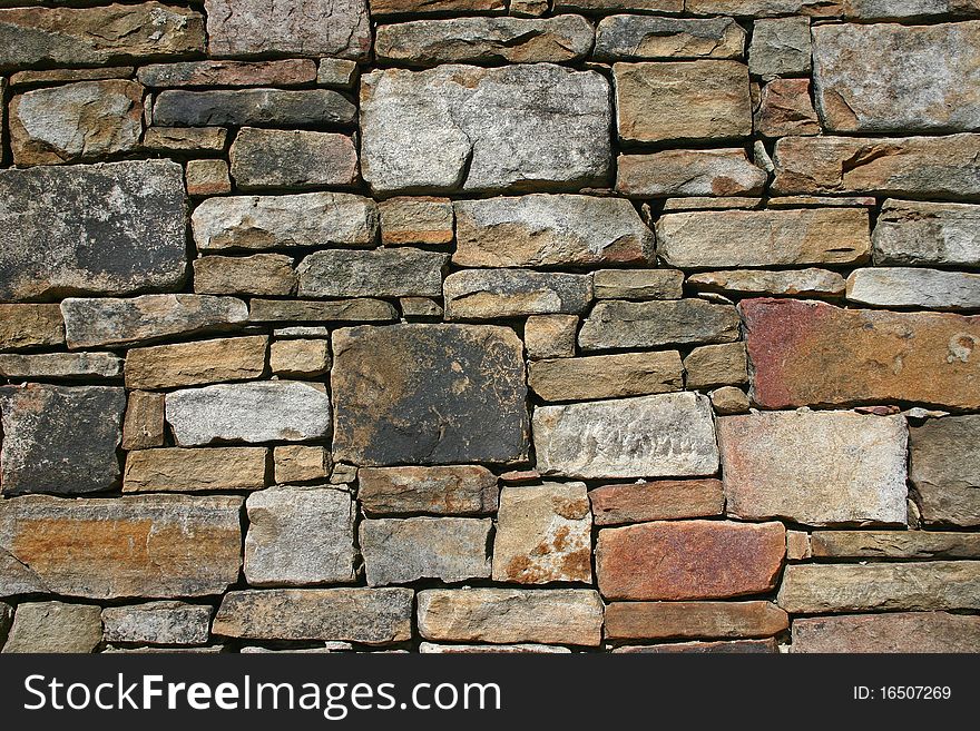 Various sizes and colors of stones in a wall. Various sizes and colors of stones in a wall