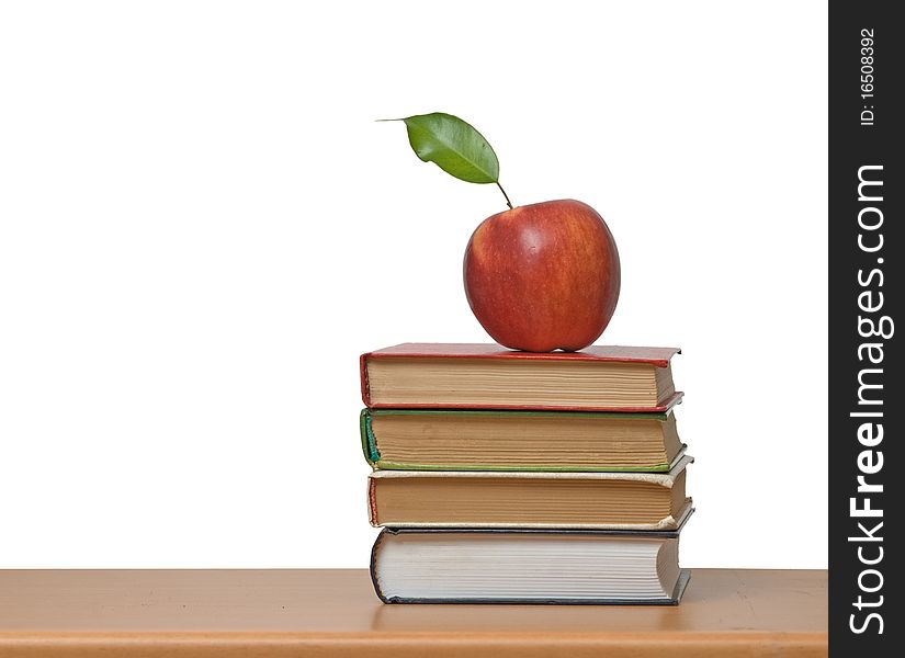 Red apple and books on desk