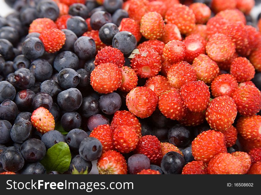 Wild strawberries and blueberries, background