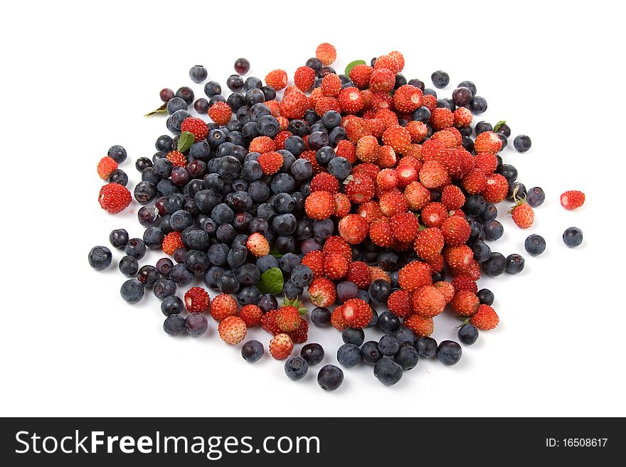 Wild strawberries and blueberries on a white background