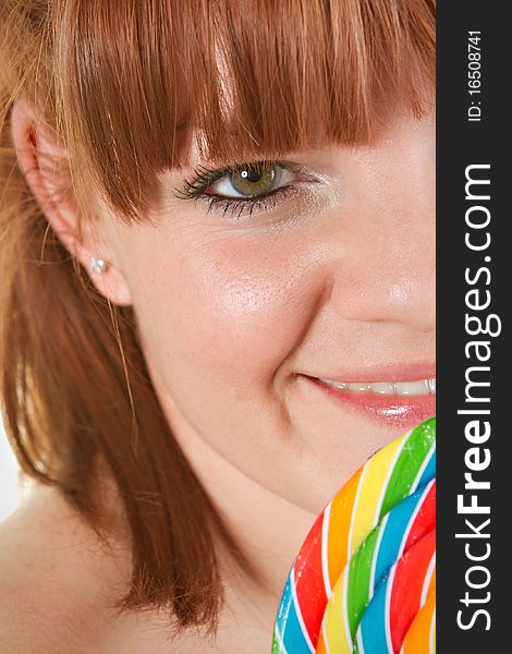 Red haired woman to lolipop - closeup. Red haired woman to lolipop - closeup.